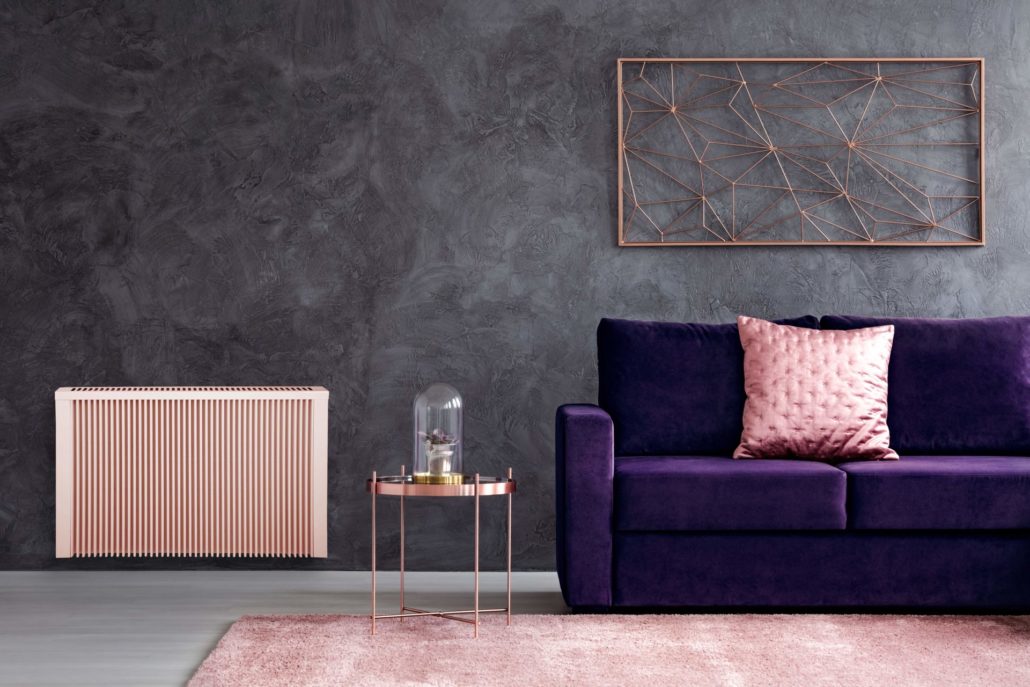 Sunflow electric radiator in stylish living room with purple sofa and salmon accents